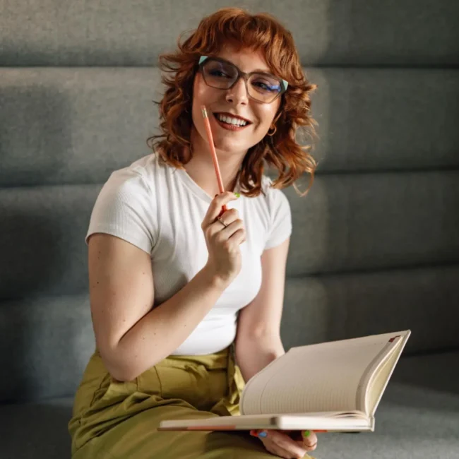 writer thinking while holding pencil and notebook
