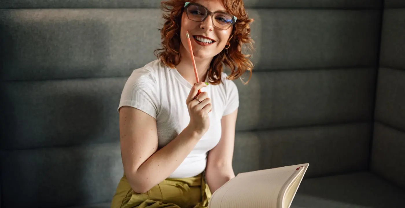 writer thinking while holding pencil and notebook